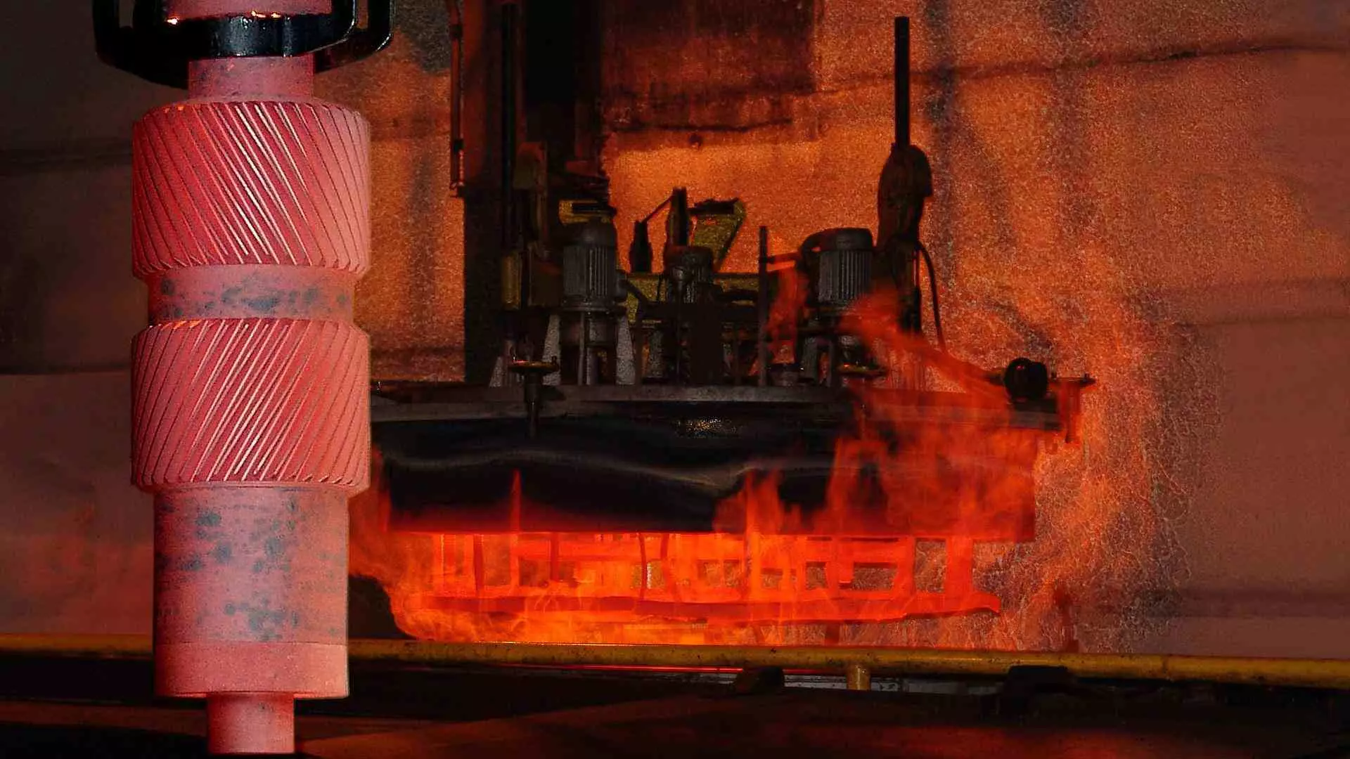 Red-hot SYMETRO intermediate pinion hanging in front of hardening furnace